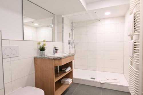a bathroom with a sink and a shower at Best Western Plus Hotel Alpenhof in Oberstdorf