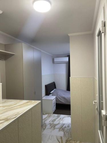 a room with a bedroom with a bed and a mirror at Апартаменти в центрі міста in Poltava