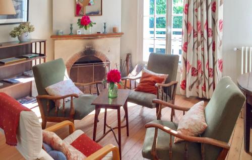 a living room with chairs and a fireplace at Amazing Home In Sainte-Marguerite-Sur- in Sainte-Marguerite