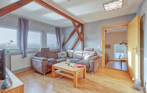 a living room with a couch and a table at Gorgeous Apartment In Nübel Ot Brekling in Brekling