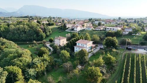 an aerial view of a town with houses and trees at Al frutteto in San Pietro di Feletto