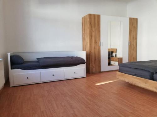 a bedroom with two beds and a mirror at FewoAltstadt76 in Gmünd