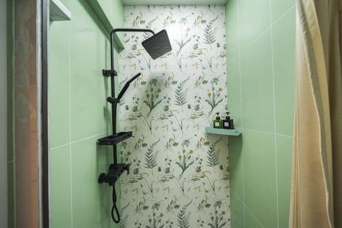 a shower in a bathroom with a shower curtain at 柃居 B&B - Jing'an Temple Branch in Shanghai