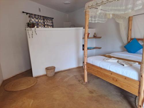 a bedroom with a bunk bed and a wooden floor at Jua Manyara Lodge & Camp Site in Mto wa Mbu