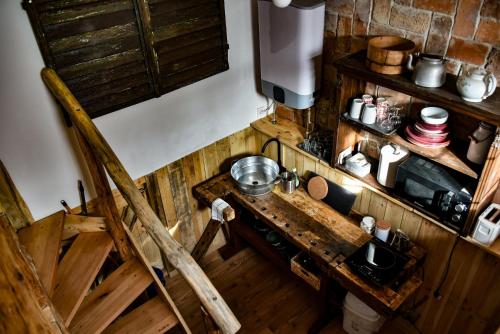 an overhead view of a kitchen with a wooden table at Halháza vendégház in Sirok