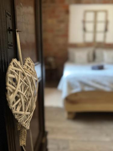 a door with a rope hanging from it with a bed at Halháza vendégház in Sirok