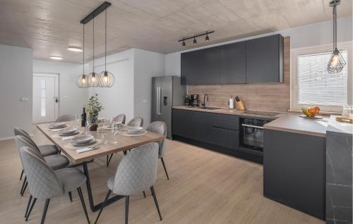 a kitchen with a table and chairs in a kitchen at Amazing Home In Krsan in Kršan