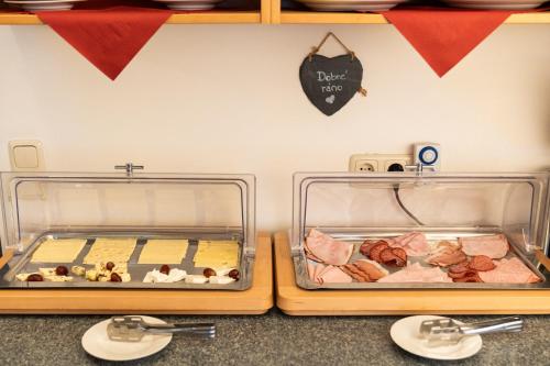 two containers of food sitting on top of a counter at Hotel Valerie in Saalbach Hinterglemm