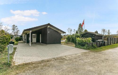 a black building with a flag on top of it at Nice Home In Strøby With Wifi in Strøby