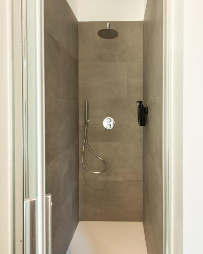 a shower stall in a bathroom with a shower at Naviglio suite apartments in Robecco sul Naviglio