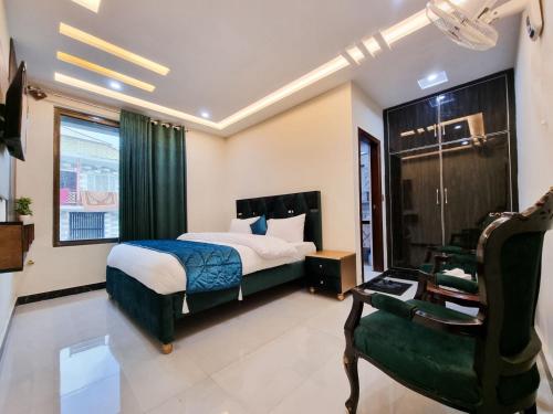 a hotel room with a bed and a chair at Hotel Summer Palace Murree in Murree
