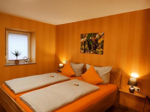 a bedroom with two beds and a window at Ferienwohnung Neubert im Taubertal in Elpersheim