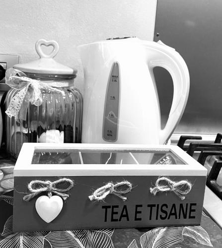 a tea set in a box next to a tea kettle at B&B L'Argonauta in Cremona