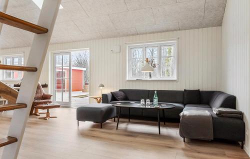 a living room with a couch and a table at Stunning Home In Glesborg With Sauna in Glesborg
