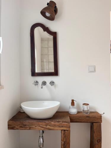 a bathroom with a white sink and a mirror at Snug Houseguests in Lisbon