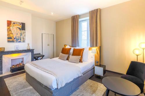 a hotel room with a bed and a fireplace at Château de Maraval in Cénac-et-Saint-Julien
