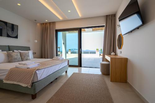 a bedroom with a bed and a sliding glass door at Lamar Private Luxury Villas in Marathias