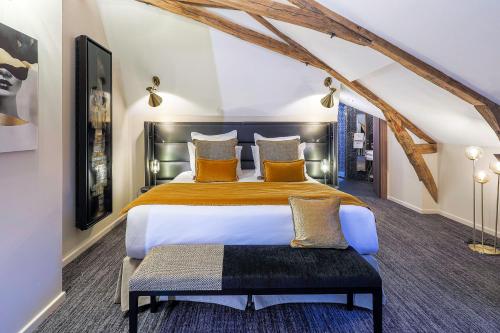 a bedroom with a large bed in a room at Château de Maraval in Cénac-et-Saint-Julien