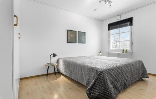 a white bedroom with a bed and a window at 5 Bedroom Pet Friendly Home In Nibe in Nibe