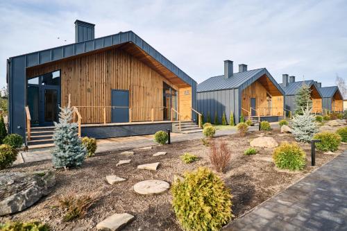 a contemporary house with a black roof at Сімейний Екопарк Ясногородка in Yasnogorodka