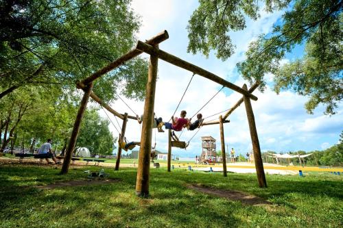 a person on a swing set in a park at Сімейний Екопарк Ясногородка in Yasnogorodka