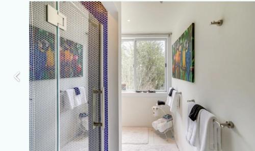a bathroom with a shower with a glass door at Cozy Mountain Home in the Catskills - Fall Views & Trails in Elka Park