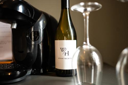 a bottle of wine sitting next to a wine glass at Exklusives Studio 1 in Steinfeld in Steinfeld