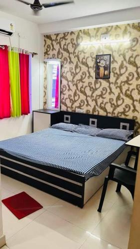 a bedroom with a large bed in a room at Hotel Nandan in Digha
