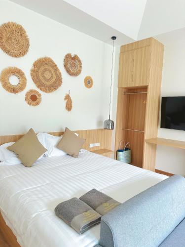 a bedroom with a bed with two pillows on it at Aonang nine poolvilla resort in Ao Nang