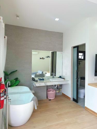 a bathroom with a bath tub and a sink at Aonang nine poolvilla resort in Ao Nang