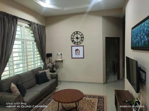a living room with a couch and a table at D'Z Homestay Jejawi Perlis in Kangar