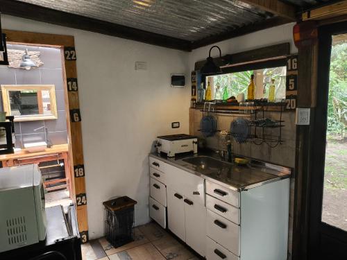 a kitchen with a sink and a counter top at El Tambucho Miramar BsAs in Miramar