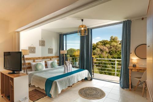 a bedroom with a bed and a large window at Villa Lira The Hidden Gem Above the Sea in Rethymno Town