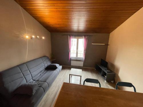 un salon avec un canapé et une table dans l'établissement Studio Périgueux 2ème étage, à Périgueux