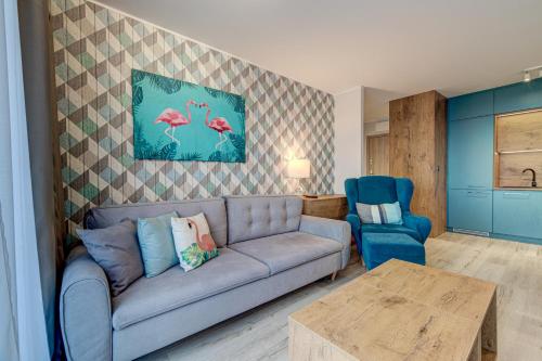 a living room with a couch and a table at Apartamenty Rondo in Świnoujście