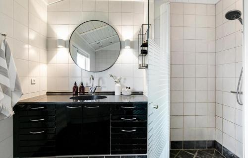 a bathroom with a sink and a mirror at Nice Home In Strøby With Wifi in Strøby