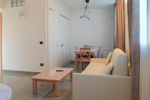 a living room with a couch and a table at L'incanto Di Boccadarno in Marina di Pisa