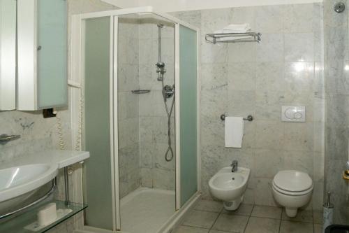 a bathroom with a shower and a toilet and a sink at L'incanto Di Boccadarno in Marina di Pisa