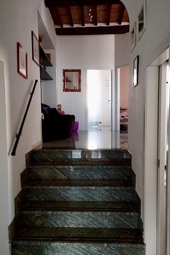 a hallway with a staircase in a house at Historic Center Apartment with Private Garage in Montalcino
