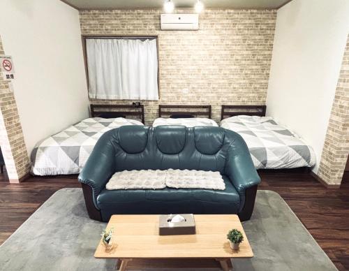 a living room with a couch and a bed at 2024 Renovation house hanasaki in Takayama