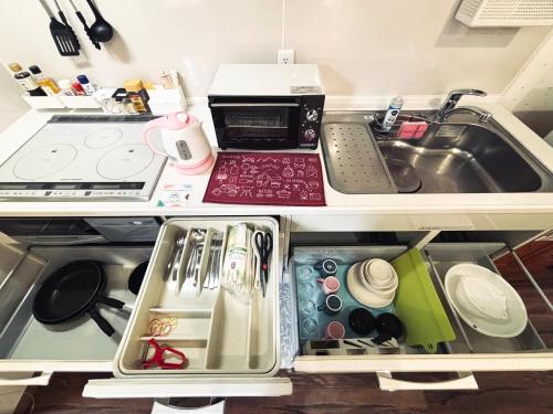 a small kitchen with a sink and a counter top at 2024 Renovation house hanasaki in Takayama