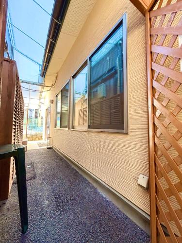 a room with windows on the side of a building at 2024 Renovation house hanasaki in Takayama