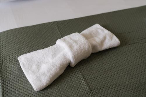 a white wrapped up sock on a bed at Apartman Krtalić in Međugorje