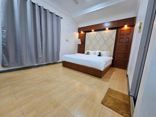 a bedroom with a bed and a large window at Grace Homestay in Kudat