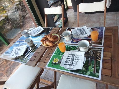 a table with a breakfast of croissants and orange juice at Chambres d'hôte Mas de Bouzou in Grèzes