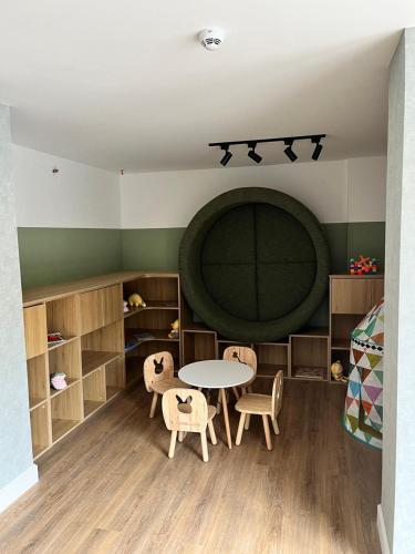 a room with a table and chairs and a bed at Sea Garden Towers PDE in Punta del Este