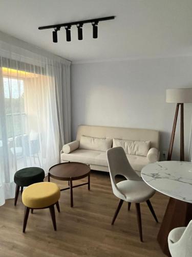 a living room with a couch and chairs and tables at Sea Garden Towers PDE in Punta del Este