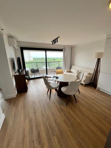 a living room with a table and chairs and a couch at Sea Garden Towers PDE in Punta del Este