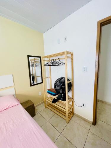 a room with a bedroom with a bed and a mirror at Morada do Mar Arraial do Cabo in Arraial do Cabo