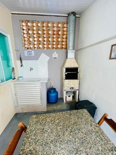 a kitchen with a stove and a table in a trailer at Morada do Mar Arraial do Cabo in Arraial do Cabo